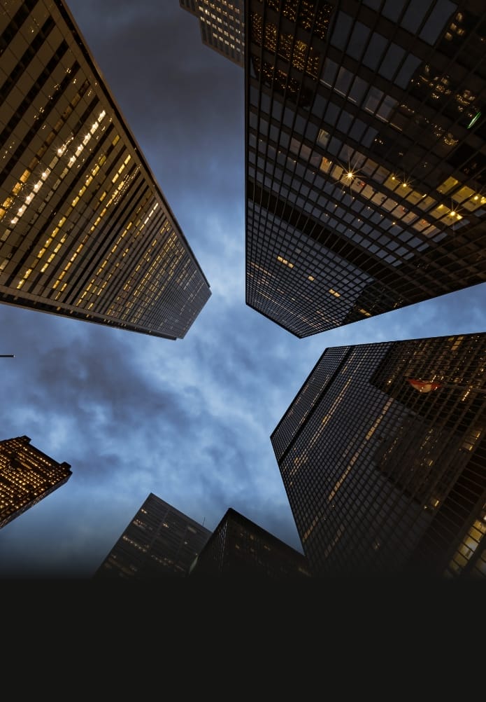 Skyscraper in the financial district, low-angle view, cloudy night sky