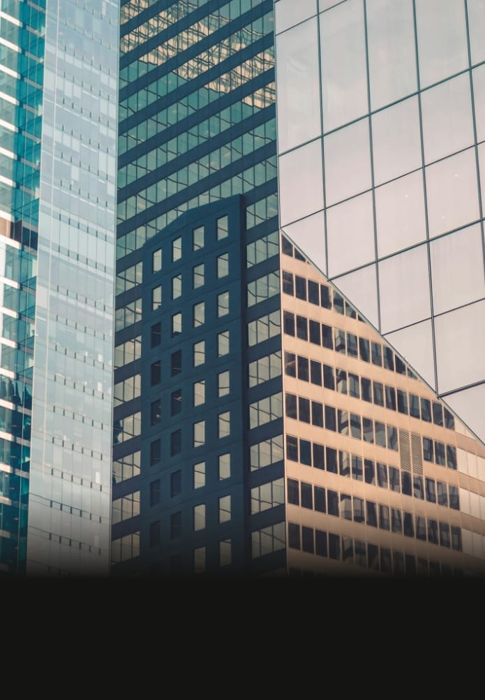 Glass skyscraper facades reflecting surrounding buildings