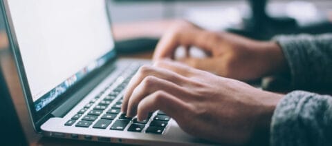 person who types on a computer keyboard